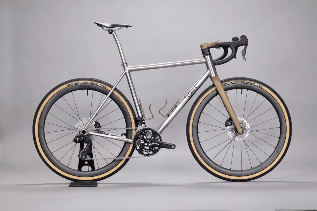 High-performance gravel bicycle with sleek metallic finish and wide tires for off-road cycling.