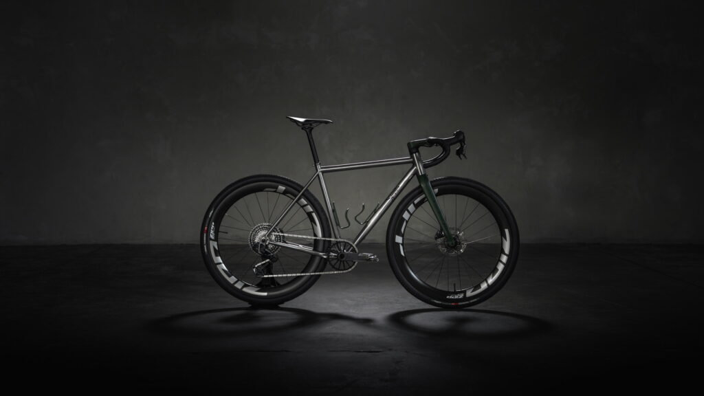 Side profile of a Simpatico Gamma Race titanium gravel bike in a studio